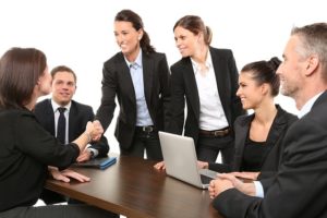 a group of managers shaking hands in the office